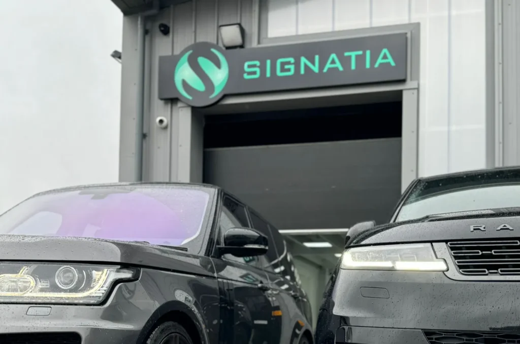 Exterior of Signatia's workshop with two Range Rovers outside with PPF protection installed.